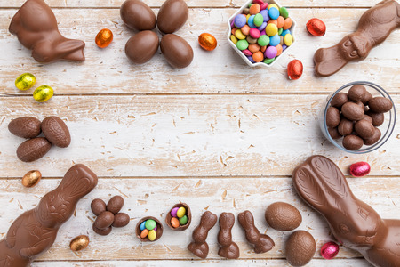 Delicious chocolate Easter bunny, eggs and sweets on rustic backgroundの写真素材