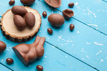 Delicious chocolate Easter bunny, eggs and sweets on rustic backgroundの写真素材