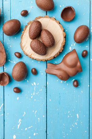 Delicious chocolate Easter bunny, eggs and sweets on rustic backgroundの写真素材