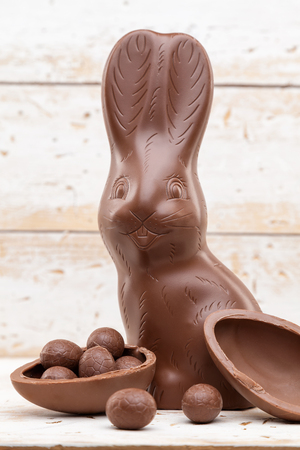 Delicious chocolate Easter bunny, eggs and sweets on rustic backgroundの写真素材