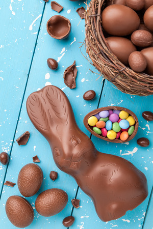 Delicious chocolate Easter bunny, eggs and sweets on rustic backgroundの写真素材