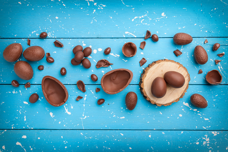 Delicious chocolate Easter bunny, eggs and sweets on rustic backgroundの写真素材