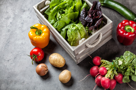 Fresh and healthy organic vegetables on a rustic backgroundの写真素材