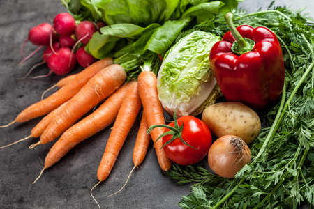 Fresh and healthy organic vegetables on a rustic backgroundの写真素材