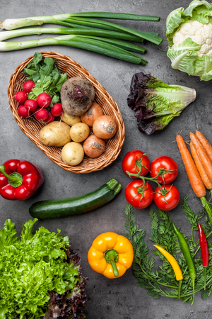 Fresh and healthy organic vegetables on a rustic backgroundの写真素材