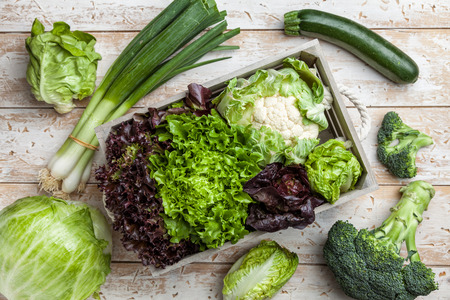 Fresh and healthy organic vegetables on a rustic backgroundの写真素材