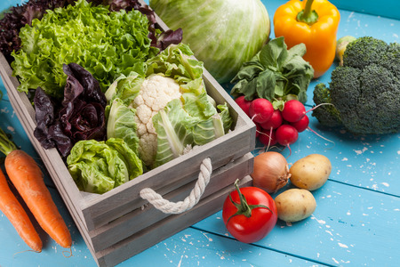 Fresh and healthy organic vegetables on a rustic background