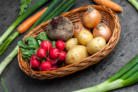Fresh and healthy organic root vegetables on a rustic backgroundの写真素材