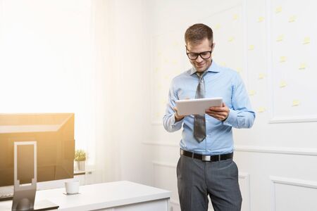 Successful handsome businessman working in his officeの写真素材