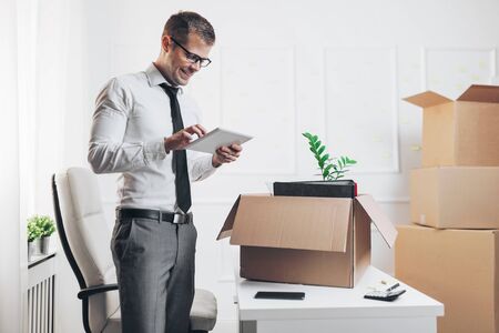 Successful businessman moving into a new officeの写真素材