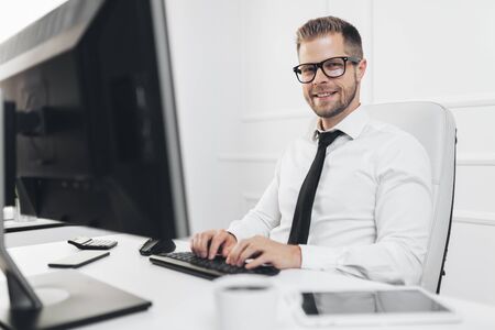 Successful handsome businessman working in his officeの写真素材