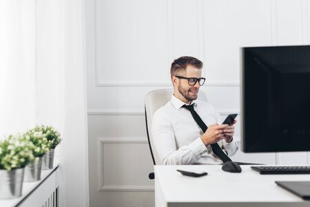 Successful handsome businessman working in his officeの写真素材