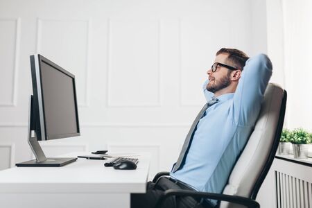 Successful handsome businessman working in his officeの写真素材