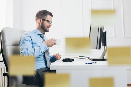 Successful handsome businessman working in his officeの写真素材