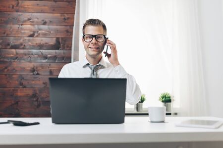 Successful handsome businessman working in his officeの写真素材
