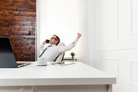 Successful handsome businessman working in his officeの写真素材
