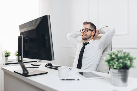 Successful handsome businessman working in his officeの写真素材