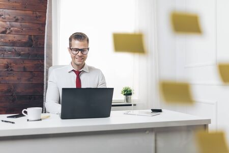 Successful handsome businessman working in his officeの写真素材