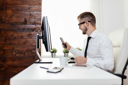 Successful handsome businessman working in his officeの写真素材