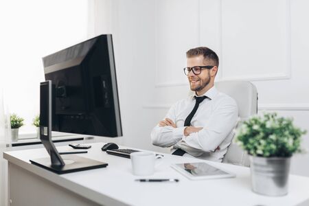 Successful handsome businessman working in his officeの写真素材