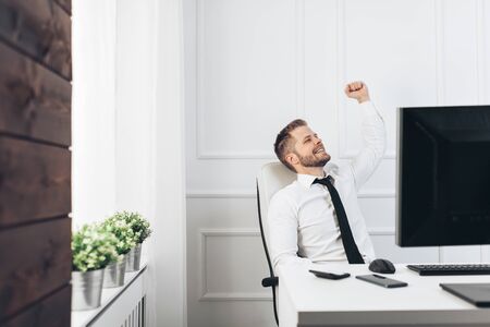 Successful handsome businessman working in his officeの写真素材