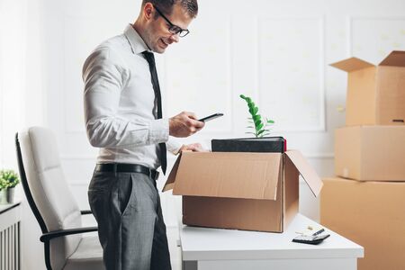 Successful businessman moving into a new officeの写真素材