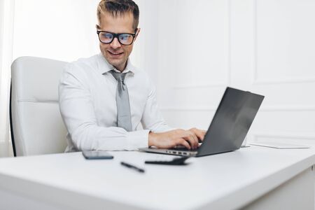 Successful handsome businessman working in his officeの写真素材