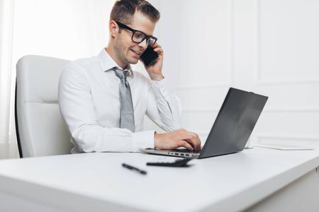 Successful handsome businessman working in his officeの写真素材