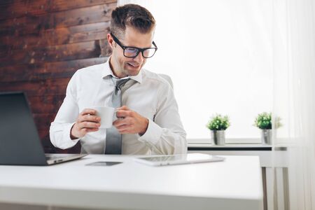 Successful handsome businessman working in his officeの写真素材