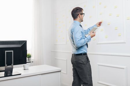 Successful handsome businessman working in his officeの写真素材