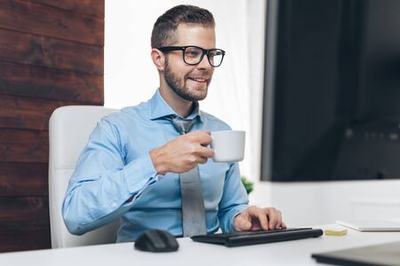 Successful handsome businessman working in his officeの写真素材