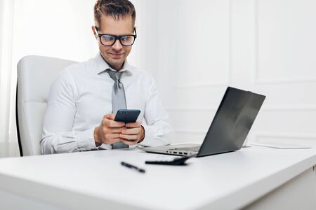 Successful handsome businessman working in his officeの写真素材