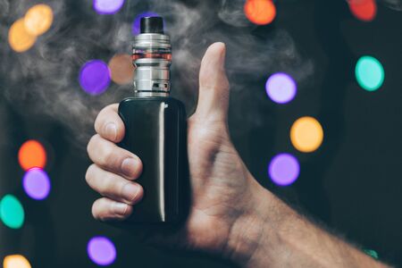 Vaping flavored e-liquid from an electronic cigaretteの写真素材