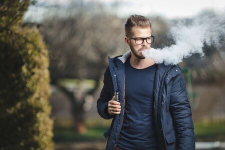 Vaping flavored e-liquid from an electronic cigaretteの写真素材