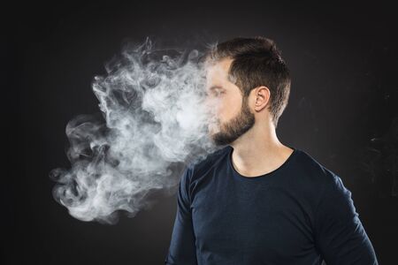 Vaping flavored e-liquid from an electronic cigaretteの写真素材