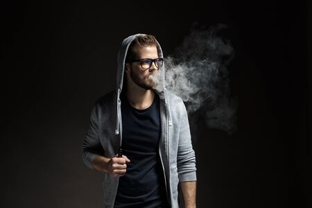 Vaping flavored e-liquid from an electronic cigaretteの写真素材