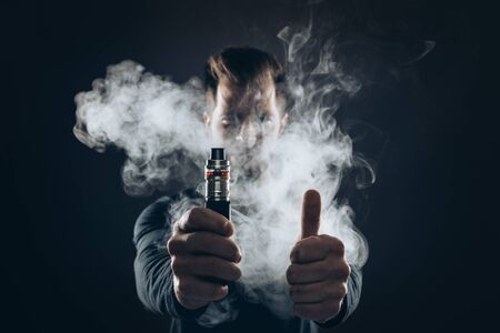 Vaping flavored e-liquid from an electronic cigaretteの写真素材