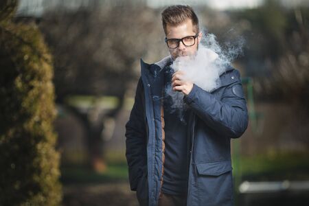 Vaping flavored e-liquid from an electronic cigaretteの写真素材
