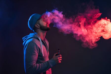 Vaping flavored e-liquid from an electronic cigaretteの写真素材