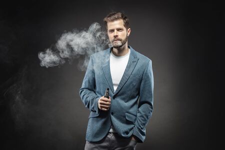 Vaping flavored e-liquid from an electronic cigaretteの写真素材