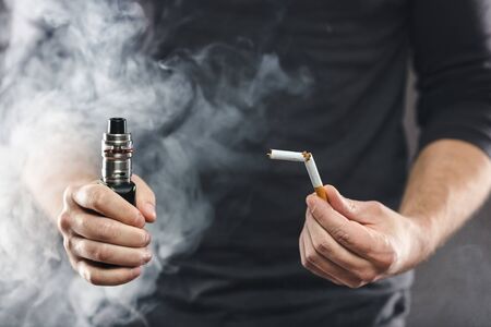 Vaping flavored e-liquid from an electronic cigaretteの写真素材