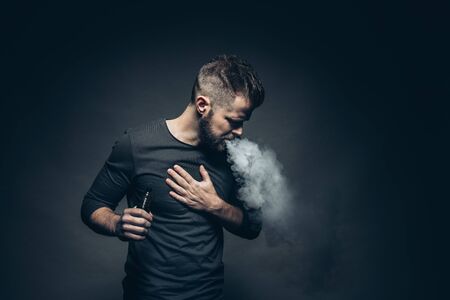 Vaping flavored e-liquid from an electronic cigaretteの写真素材
