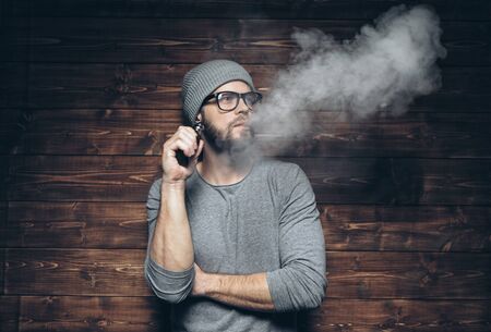 Vaping flavored e-liquid from an electronic cigaretteの写真素材