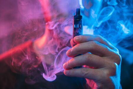 Vaping flavored e-liquid from an electronic cigaretteの写真素材