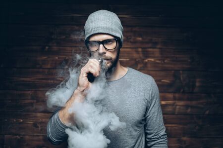 Vaping flavored e-liquid from an electronic cigaretteの写真素材