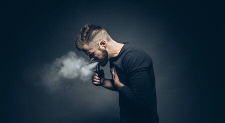 Vaping flavored e-liquid from an electronic cigaretteの写真素材