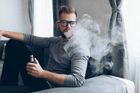 Vaping flavored e-liquid from an electronic cigaretteの写真素材