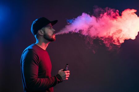 Vaping flavored e-liquid from an electronic cigaretteの写真素材