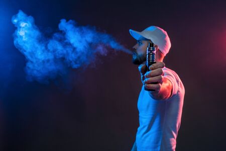 Vaping flavored e-liquid from an electronic cigaretteの写真素材