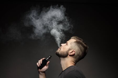 Vaping flavored e-liquid from an electronic cigaretteの写真素材
